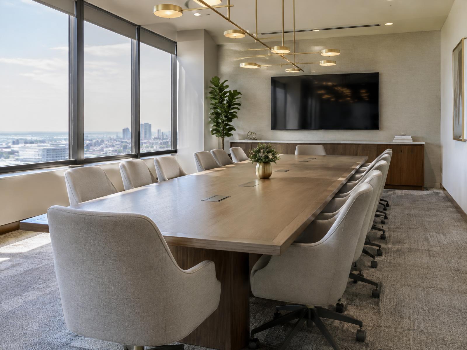 Conference room with a long wood table and upholstered chairs for client meetings